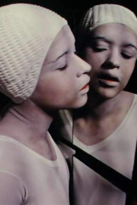 A woman in white dances and mimes across a red floor, her movements reflected in a fractured wall of mirrors. Her mirror image gains agency, turning a self‑to‑self dialogue into a self‑to‑other encounter. The film probes identity, self versus other, and how viewers engage with the onscreen body, questioning cinematic identification.