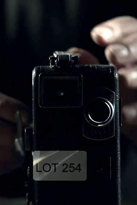 A Collector repairs a vintage cine camera unlocking the hidden terror of LOT254.